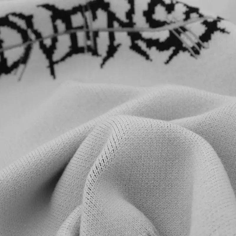 DISTRESSED BLACK SWEATER WITH RETRO SKULL GRAPHIC